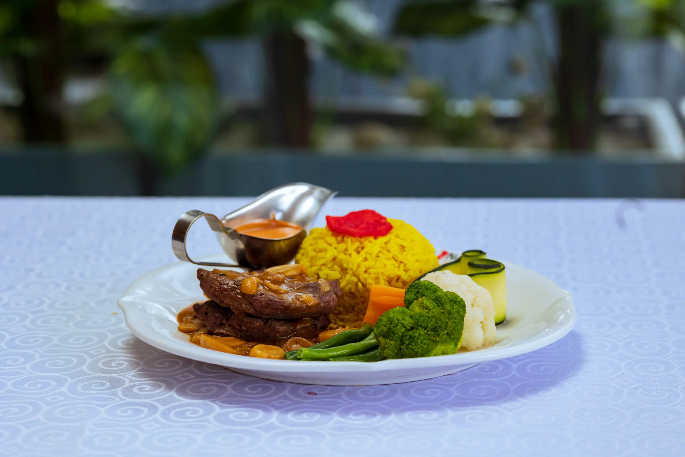 Beef served with seasoned rice and vegetables